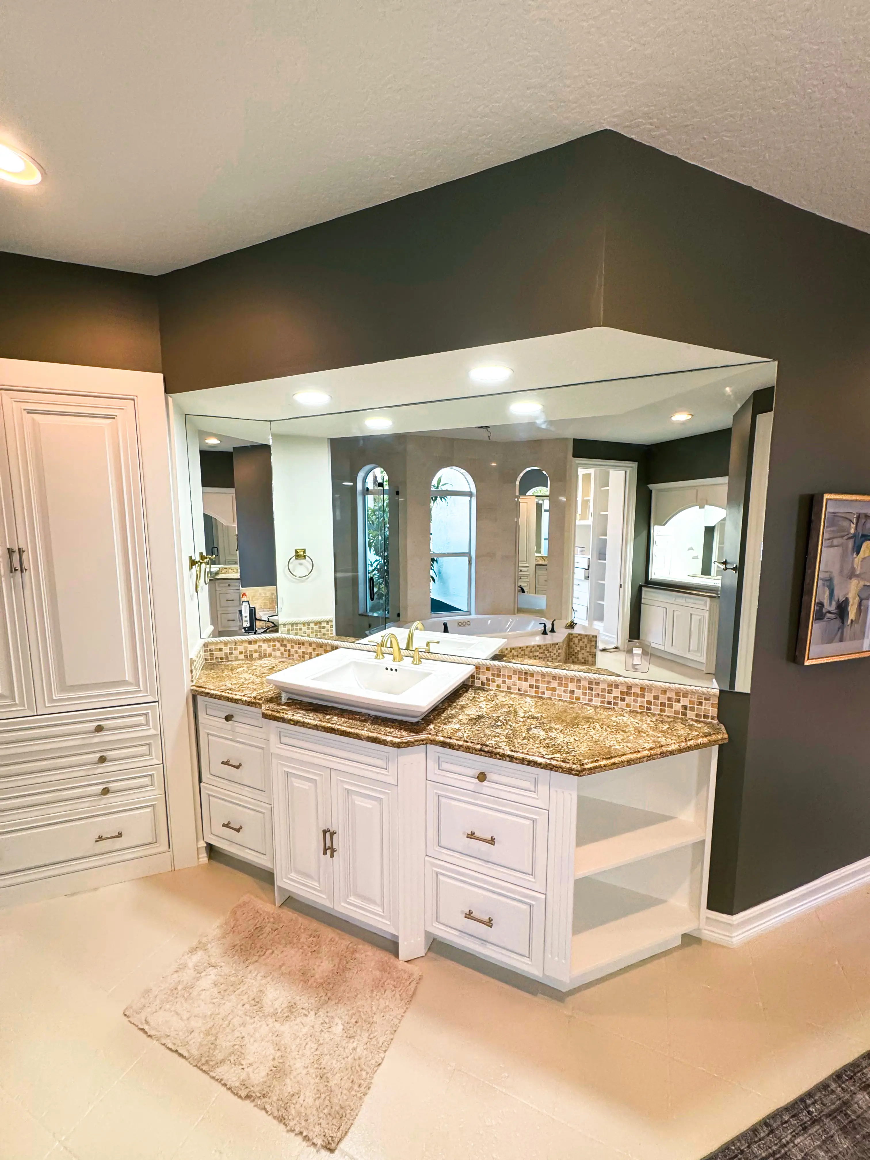 Beautiful bathroom mirror with custom glass, vanity, and elegant fixtures.
