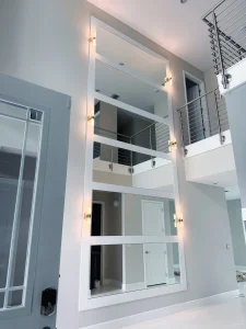 Large decorative mirror wall with multiple panels enhancing modern interior design.