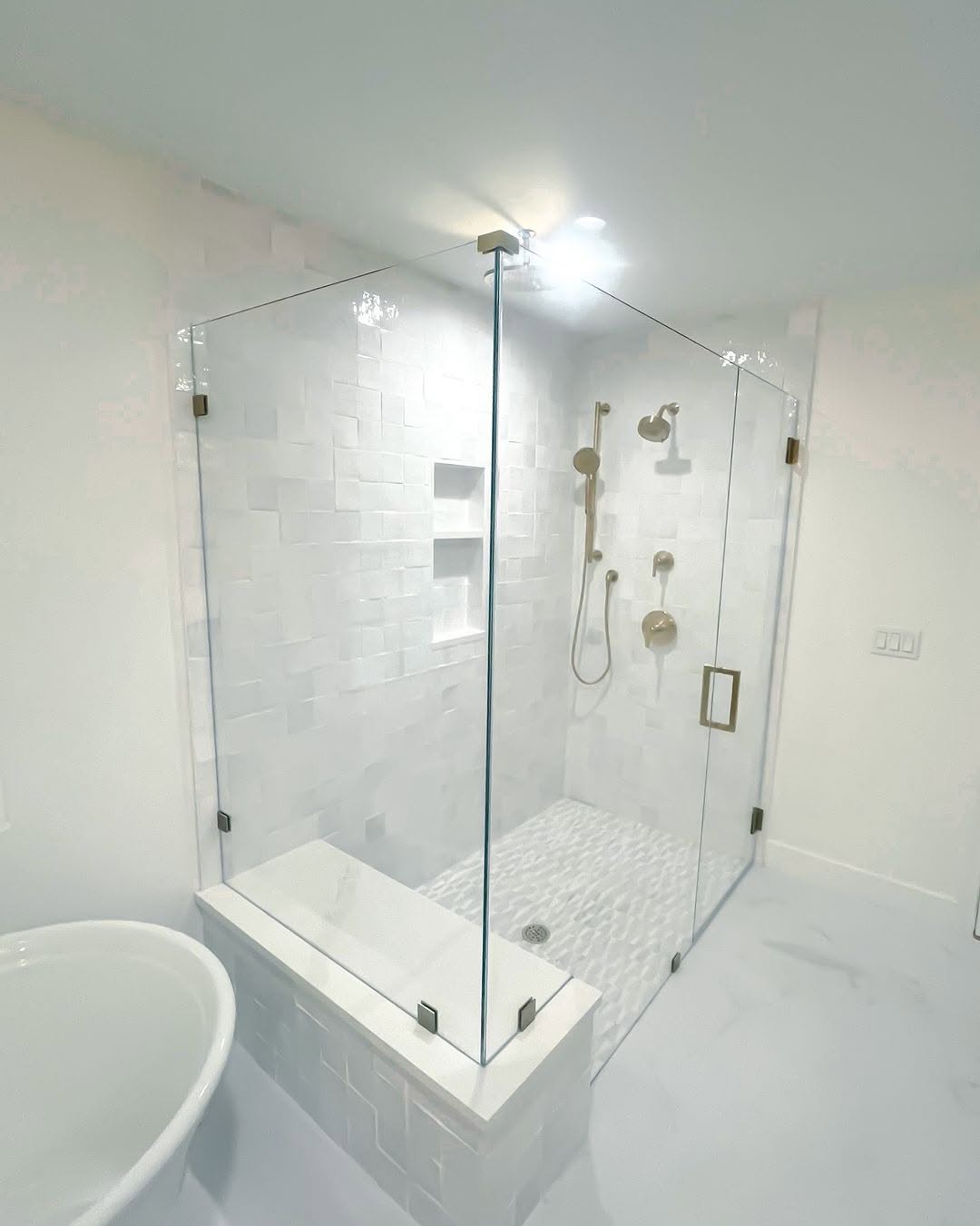 High-quality glass shower door with brass hardware, sleek design, and waterproof tiles. Perfect for modern bathrooms.