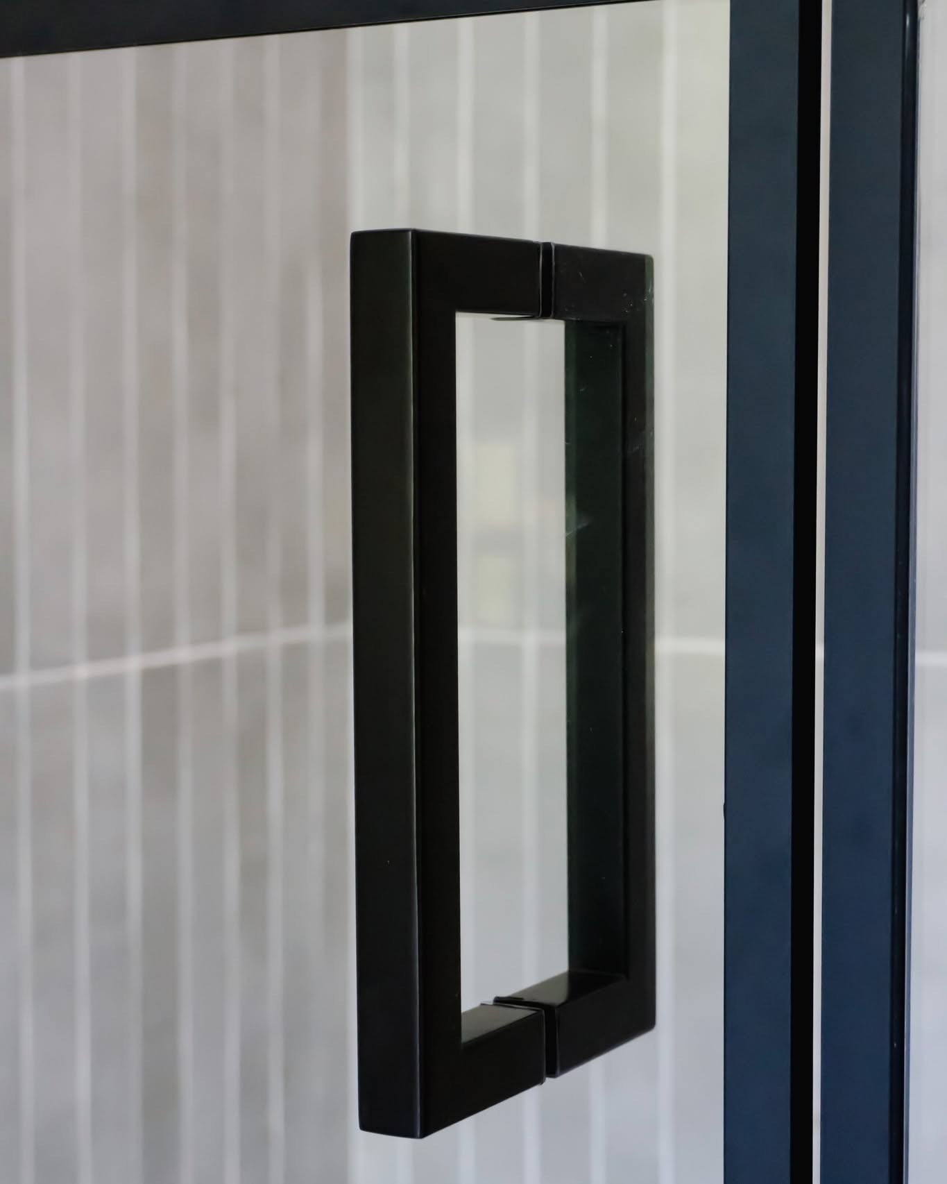 Contemporary black glass door handle for home or office doors.