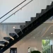 Elegant glass staircase with sleek handrail and modern design in upscale home.
