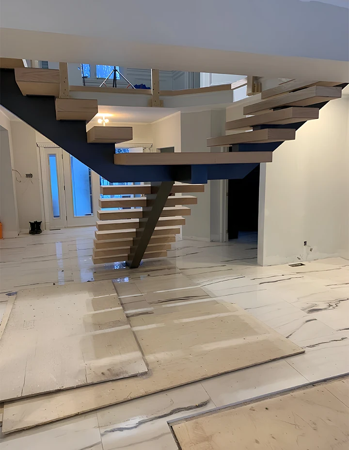 Alt: Custom wood floating staircase with sleek design in modern home interior.