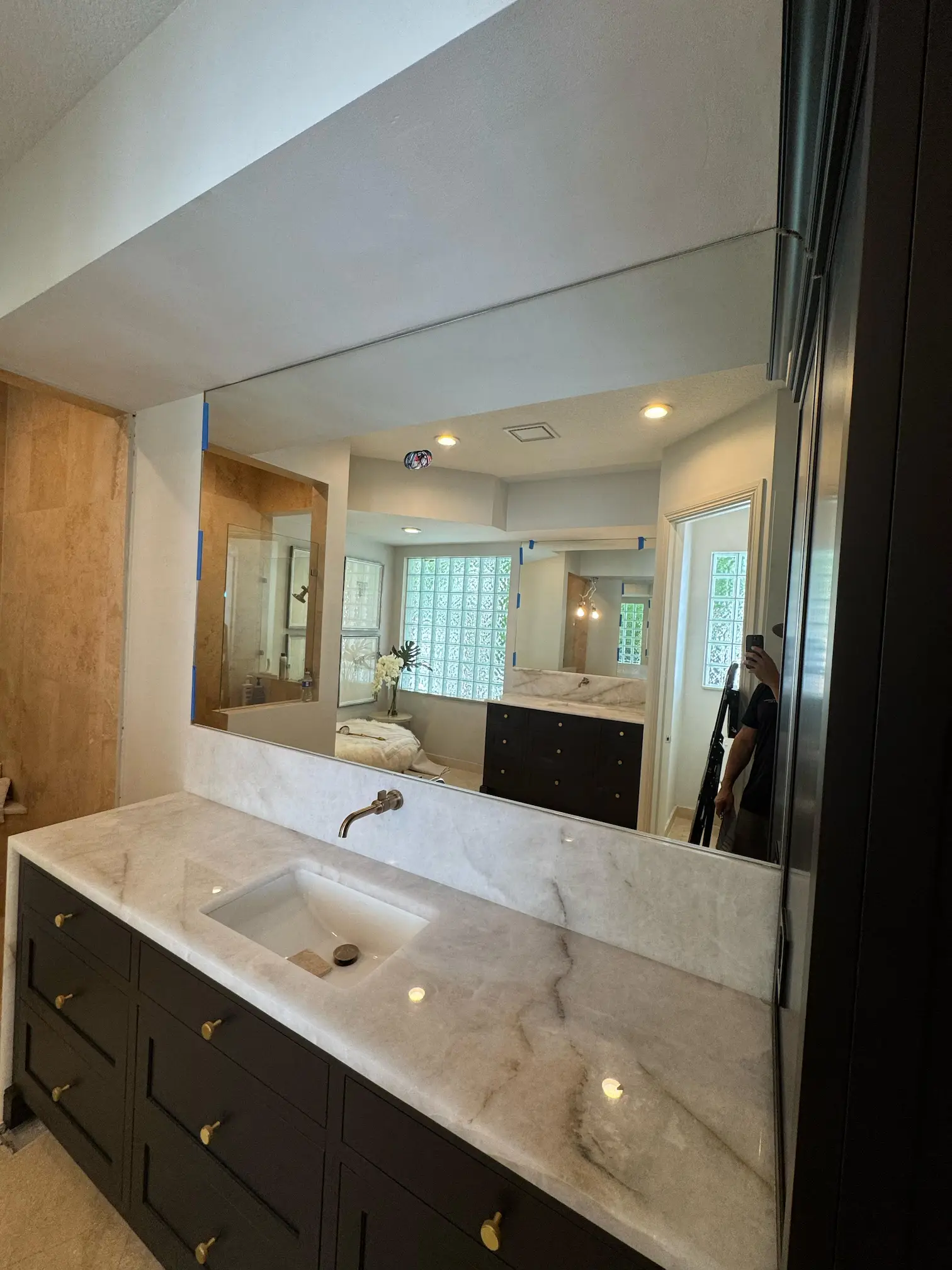 High-quality crystal glass mirror in a luxurious bathroom setting featuring marble vanity and elegant decor.