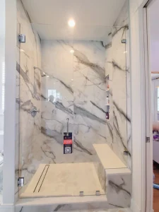 High-end glass shower enclosure with marble accents for luxurious bathrooms.