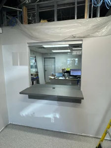 High-quality glass window with sliding door for office communication.