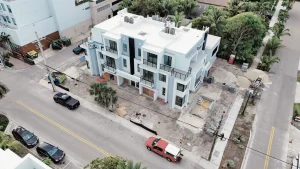 Aerial view of contemporary glass and mirror residential building during construction.
