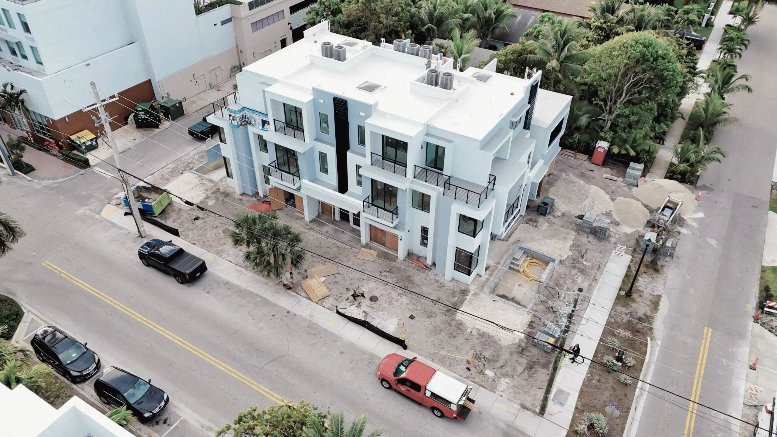 Aerial view of contemporary glass and mirror residential building during construction.