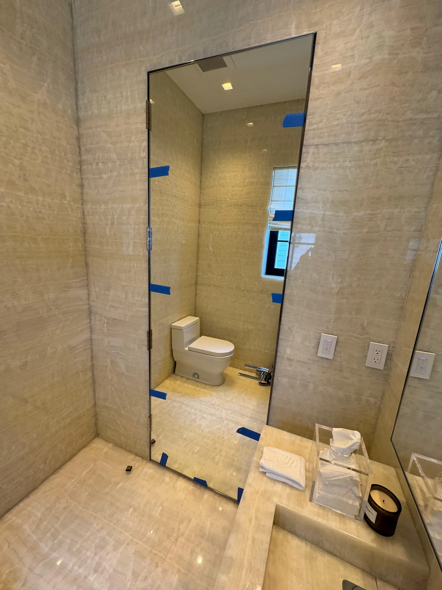High-quality crystal glass mirror installation in modern bathroom.