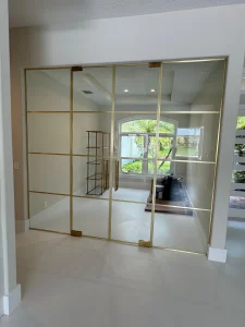 Elegant gold-framed mirrored glass closet doors for stylish home decor.