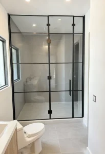 High-quality glass shower door with black metal frame for modern bathrooms.