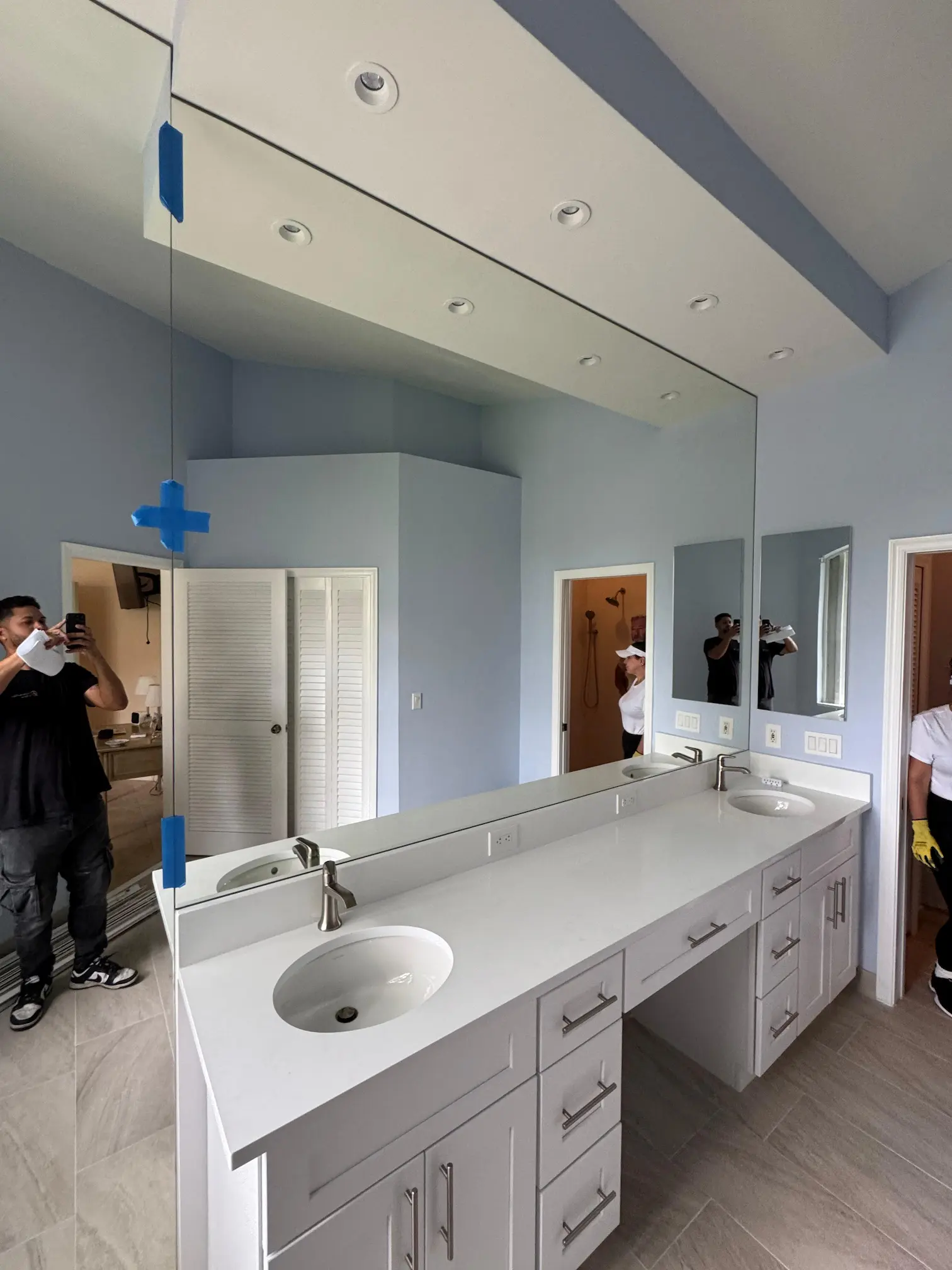 Bright bathroom mirror with double sink and contemporary vanity setup.