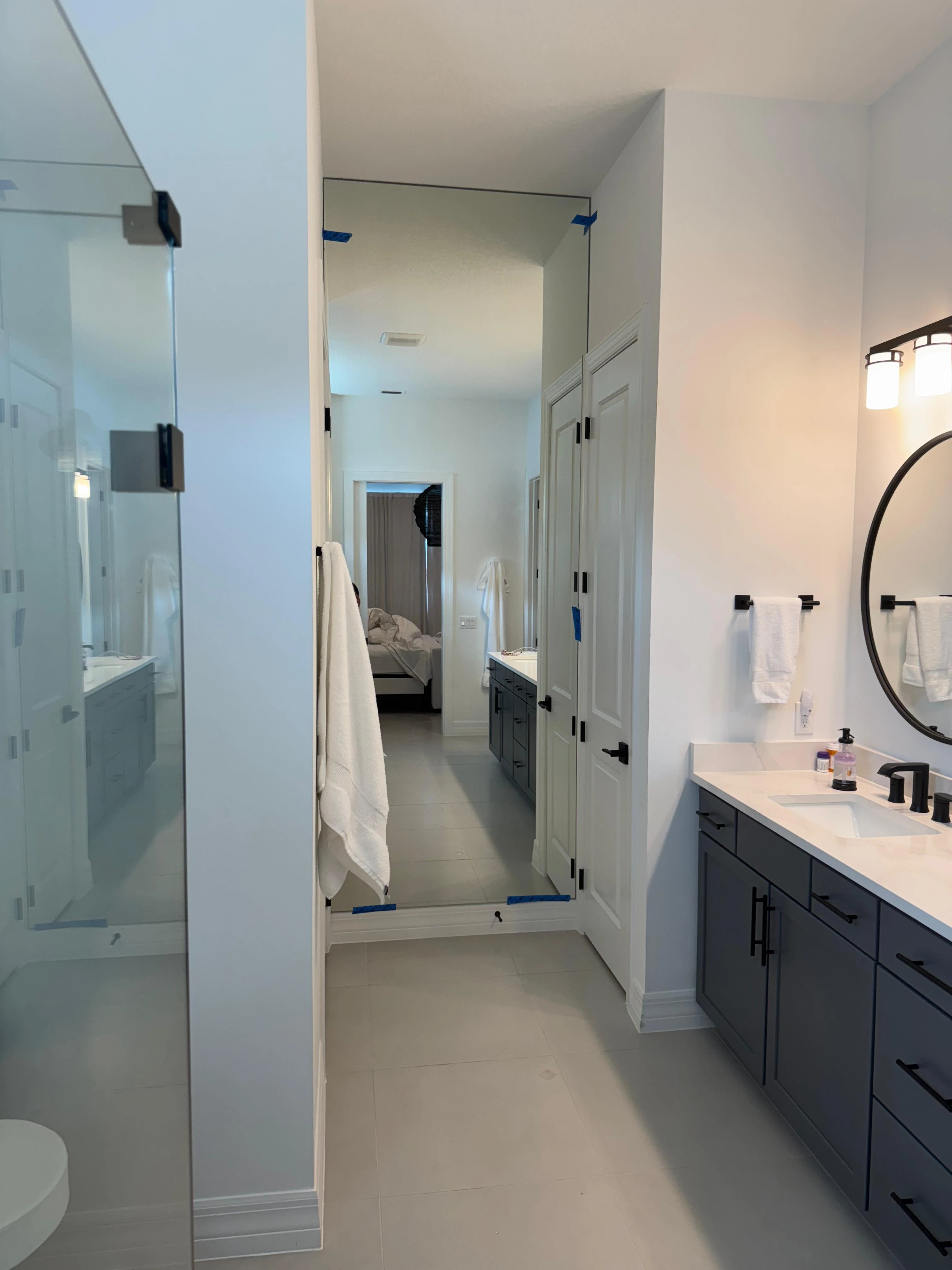 Upgraded modern bathroom with large mirror and sleek vanity for a contemporary look.