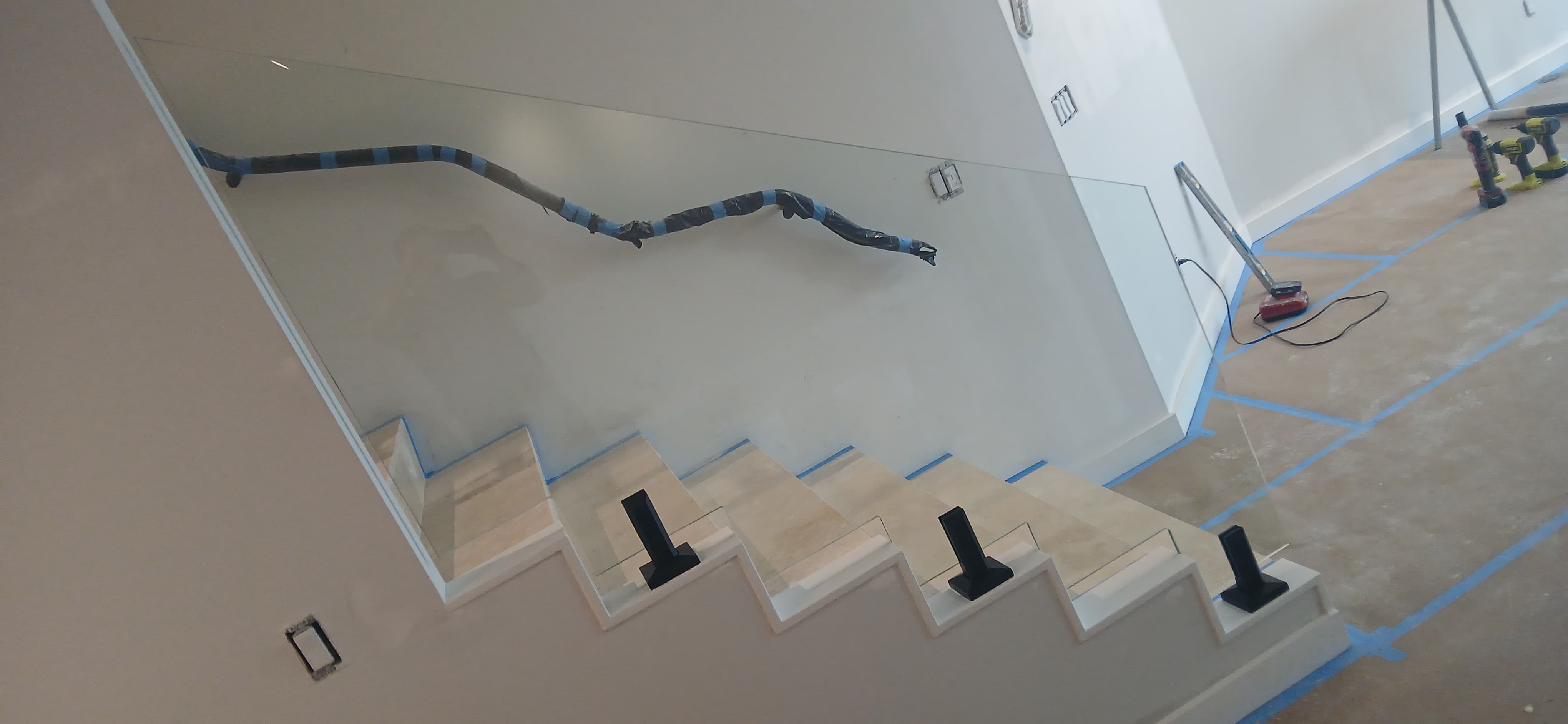 Beautifully crafted glass and mirror installation in a modern staircase setting, enhancing home decor.