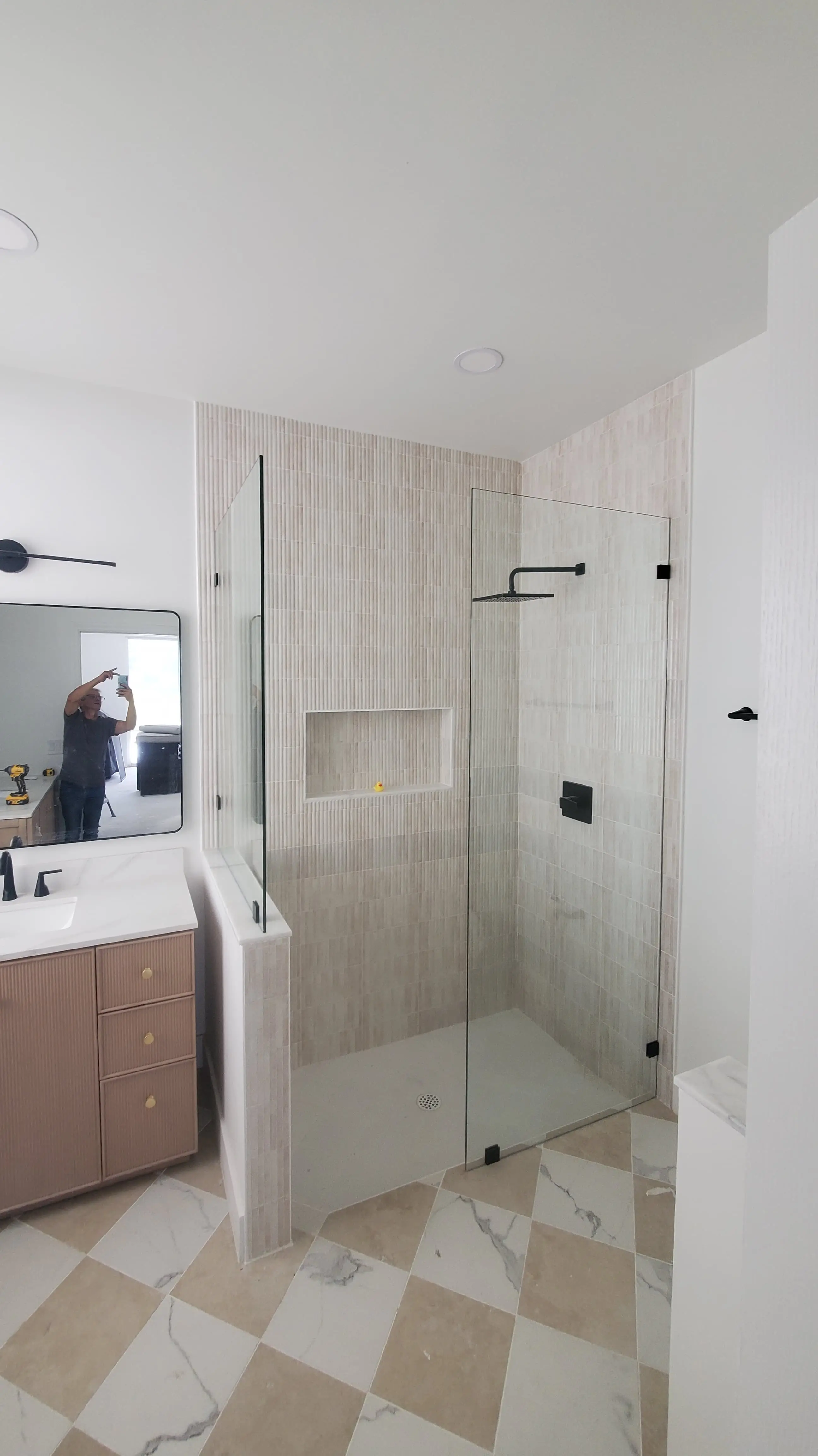 High-quality glass shower door with sleek black fixtures, minimalist style bathroom upgrade.