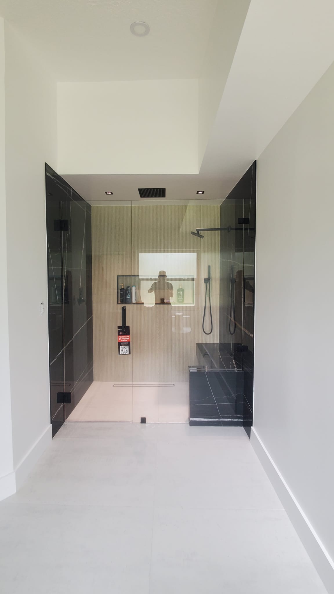 High-quality glass shower and mirror installation in modern bathroom design.