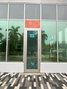 High-quality glass and mirror installation on modern commercial storefront with reflective windows.