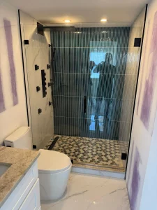 High-quality glass shower door with matte black hardware and stylish tile floor.