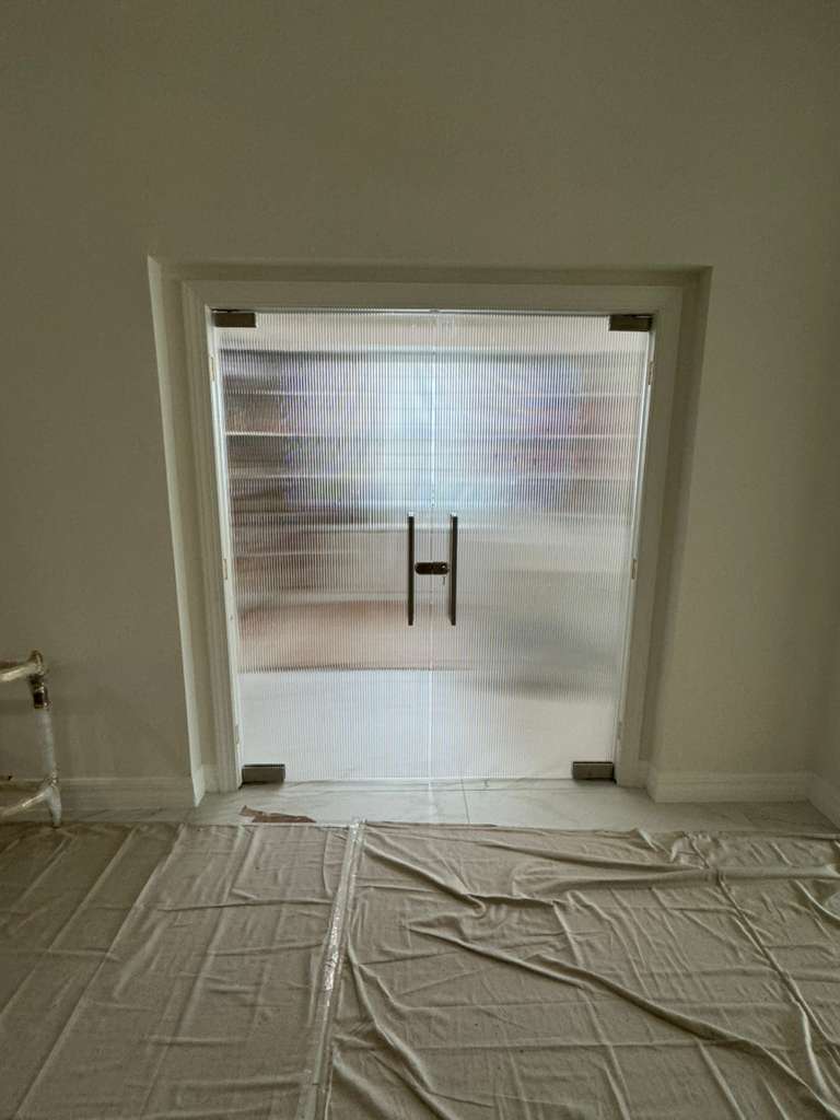Stunning glass and mirror door enhances modern interior design and privacy solutions.