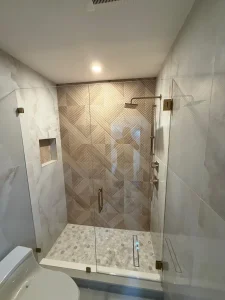 High-quality clear glass shower door with sleek metal hardware in contemporary bathroom setting.