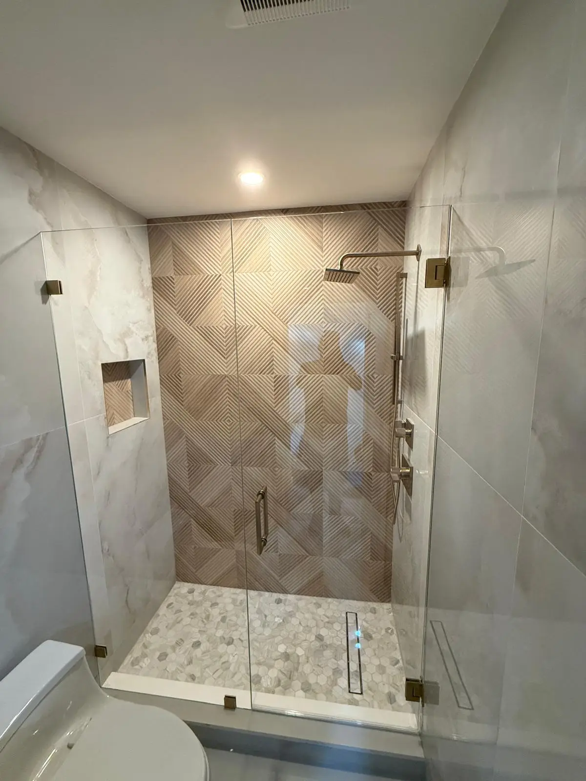 High-quality clear glass shower door with sleek metal hardware in contemporary bathroom setting.