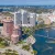 Detailed view of Miami's skyline near the water with modern glass buildings and boats.
