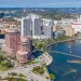 Detailed view of Miami's skyline near the water with modern glass buildings and boats.