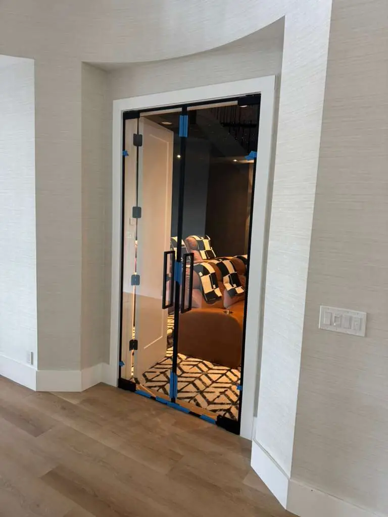 Elegant glass and mirror door with black frame and handle.