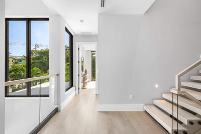 Modern glass and mirror accents enhance the interior of the Duplex Andrews Ave project.