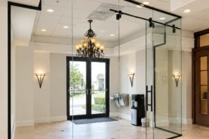 Frameless glass partition with a sliding door in a medical office lobby in Palm Beach Gardens