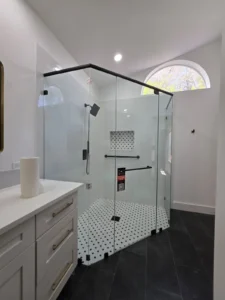 Curbless neo angle shower with a matte black header and clear glass panels in a Palm Beach Gardens bathroom