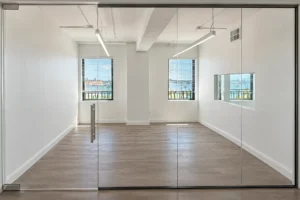 Frameless glass office front with swing door in Suite 705 of The Citizens Building, West Palm Beach
